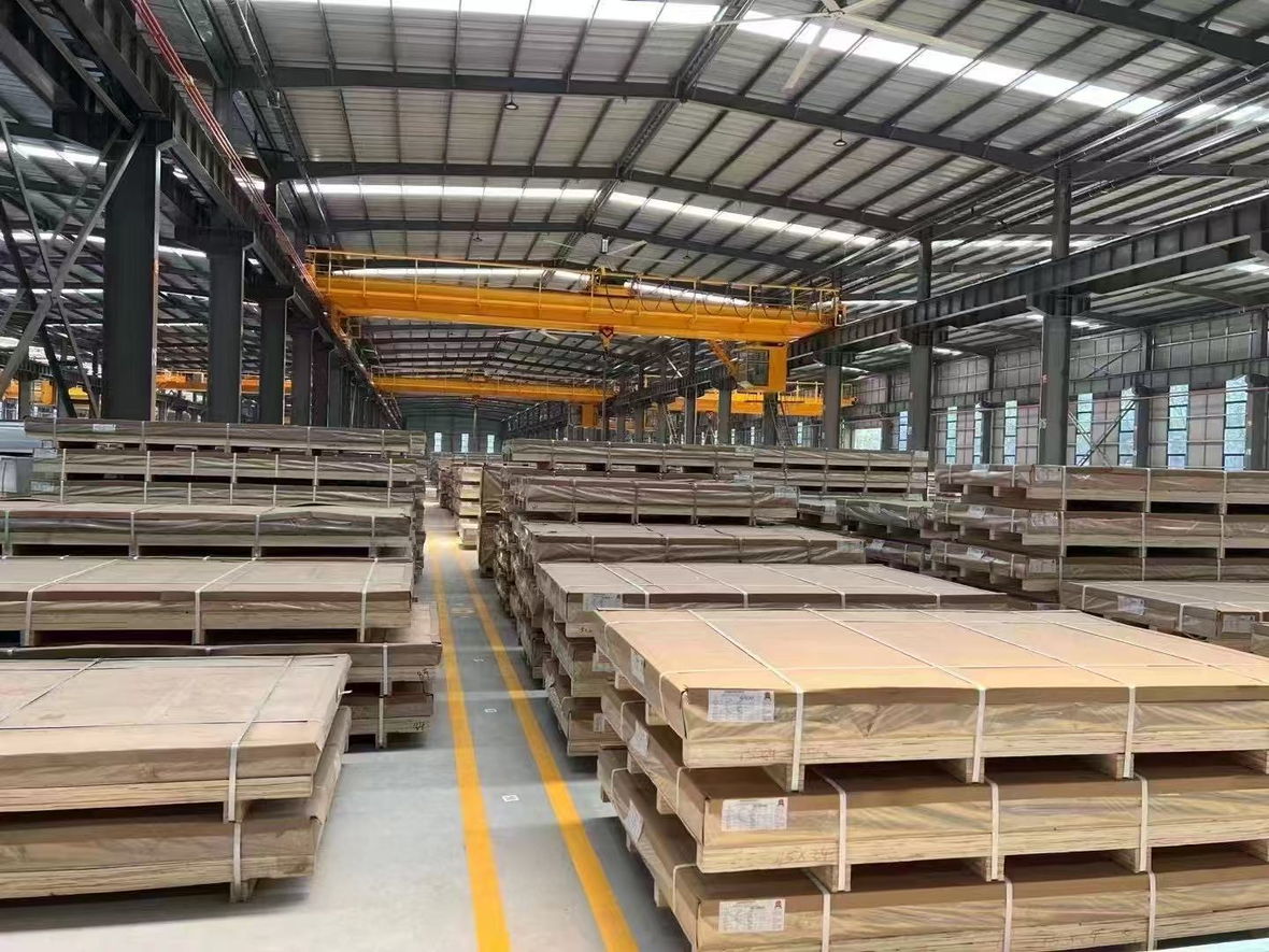 Stock hall with packed plate bundles and overhead cranes